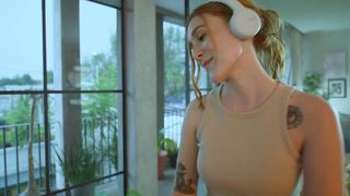 Woman cleaning her house dancing happy