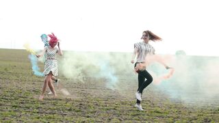Friends with colored smoke bombs