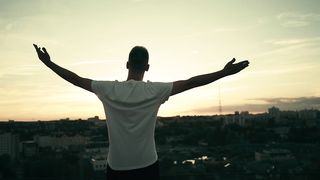 Man over a roof feeling motivational