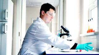 Scientist in a laboratory preparing a sample