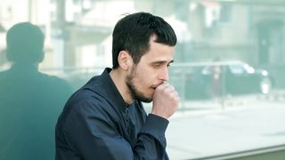 Sick man with coronavirus symptoms in the street
