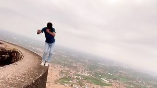 JUMPING ON THE EDGE OF MOUNTAIN