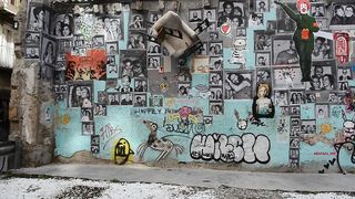 Wall with portraits and graffiti