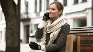 Woman talking on the phone on a public bench