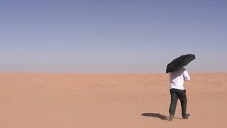 funny Men with umbrella in the desert !
