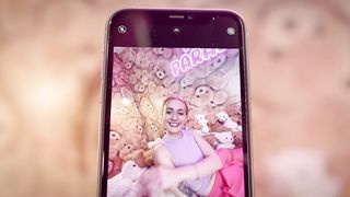 A young woman having fun in a teddy bear-themed room