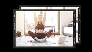 Blond  girl doing her gym workout at home while watching online video