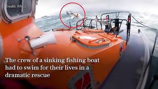 Crew members jump off sinking ship and swim for their lives in dramatic rescue video