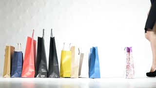 Fashionable women pick up shopping bags on white background