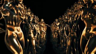 Golden sculptures of human figures, loop video