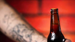 Opening a beer bottle close up view