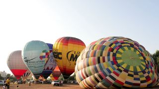  air balloons taking off from the ground