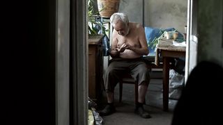 Old poor hungry man counting coins