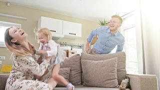 Happy parents playing with their daughter