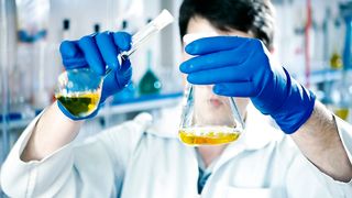 Scientist mixing liquids in a laboratory