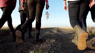 Group of people walking on a dirt road
