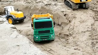 RC Excavator fills sand into RC Dump Truck