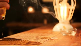Taking a glass of beer from a bar