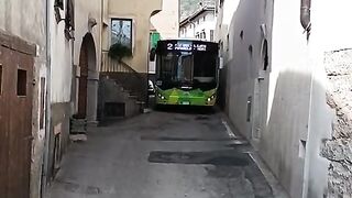 A regular bus on a narrow street in Italy
