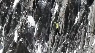 Walking on a rope stretched at a great height between rocks
