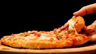 delicious pizza dripping with cheese