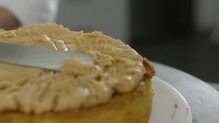 Pastry chef putting the filling on a cake