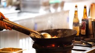 A Cook Using A Wok