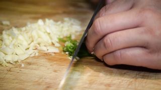 Person Cutting Parsley Leaves