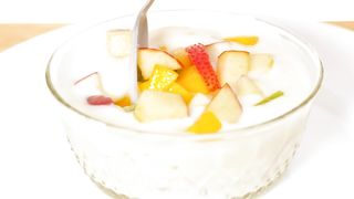 Bowl with yogurt served with chopped fruit