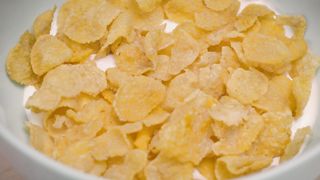 Corn flake cereal in a bowl with milk