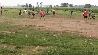 "Playing soccer on the field."