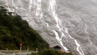 A place in New Zealand where many waterfalls follow the slopes of a mountain