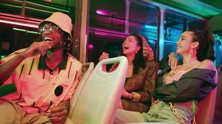 Friends laughing on a bus