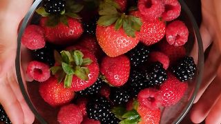 Red berries served in a bowl on a wooden table