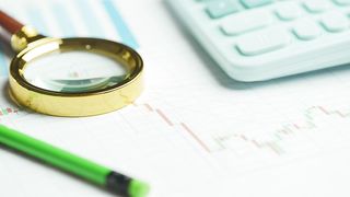 Documents with magnifying glass on a table