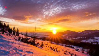 Sunset over a snowy winter mountain