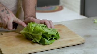 Chef chopping a lettuce