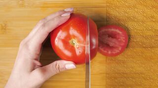 slicing tomato on a board