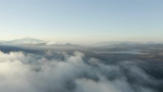 Aerial tour above a cloudy
