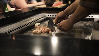 Chef cooking on a large grill