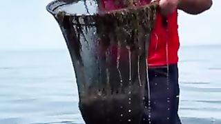 A man cooks freshly caught shrimp