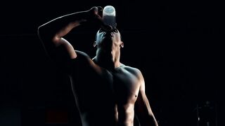 A bodybuilder is drinking water