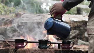 Man serving  water in the forest