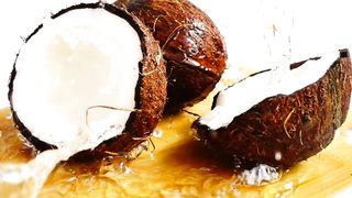 Pair of coconuts being wet by coconut water