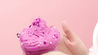 Woman showing pink ice cream shaped plasticine