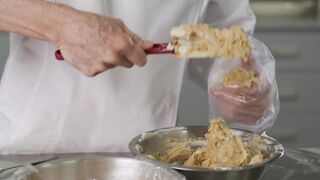 Pastry chef filling a piping bag