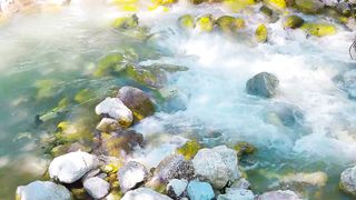 Flowing water over moss covered rocks