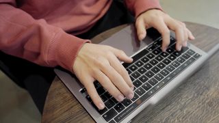 young-man-typing-on-a-laptop