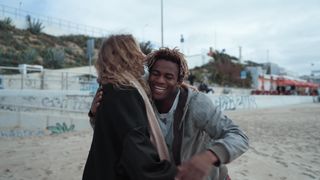 friends-happily-hugging-each-other-on-the-beach