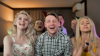 Excited young people partying with party hats